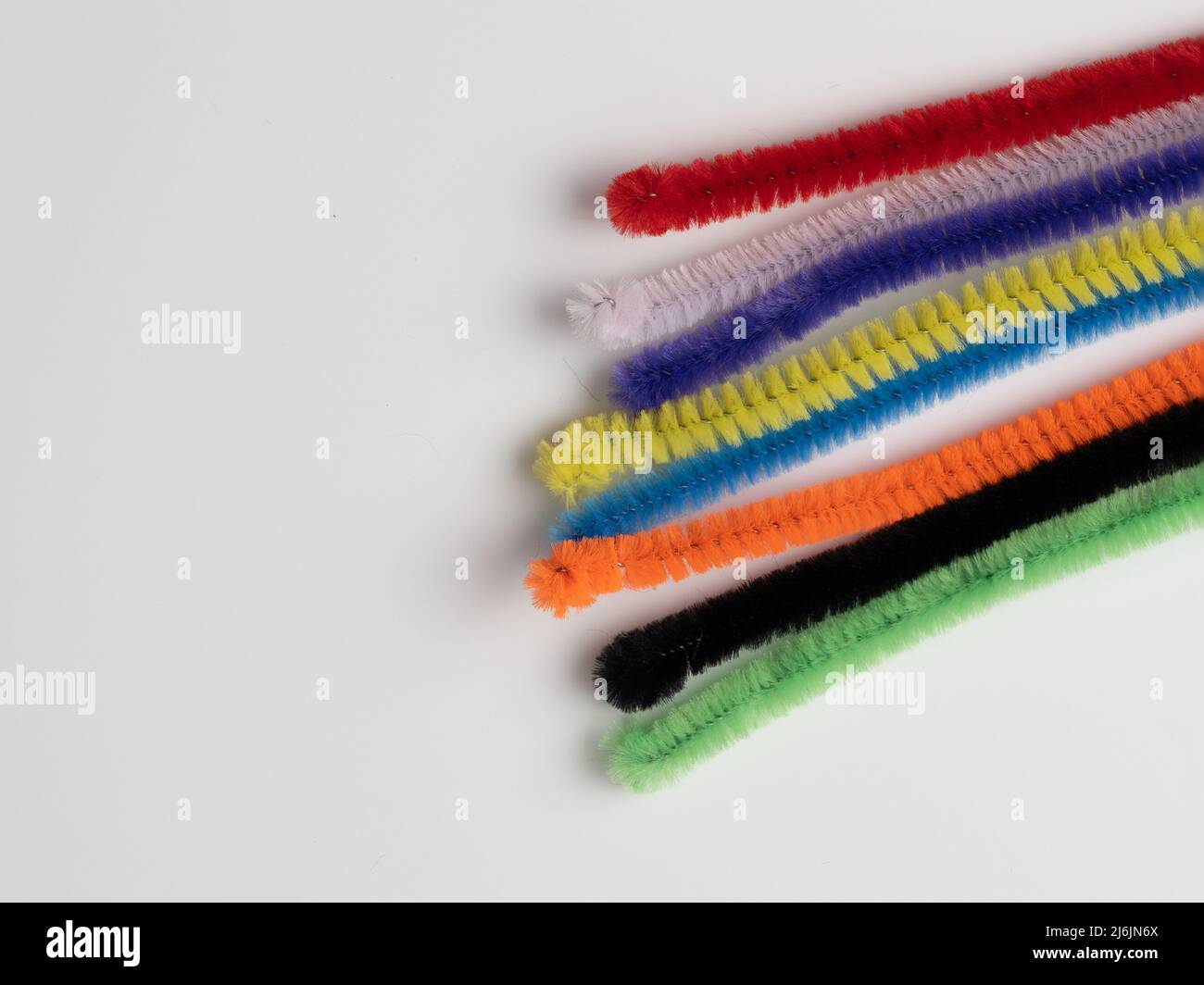 rainbow pipe cleaner ends  on a white background Stock Photo