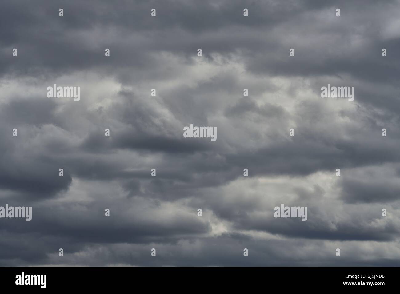 Cloudy sky with rays of sun shining through Stock Photo