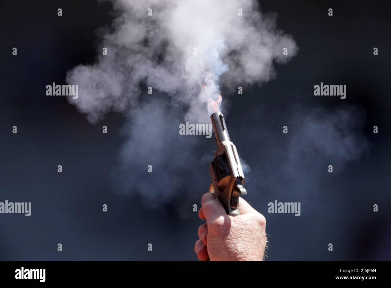 An official fires a starter's pistol during the 126th Penn Relays, Friday, Apr. 29, 2022, in