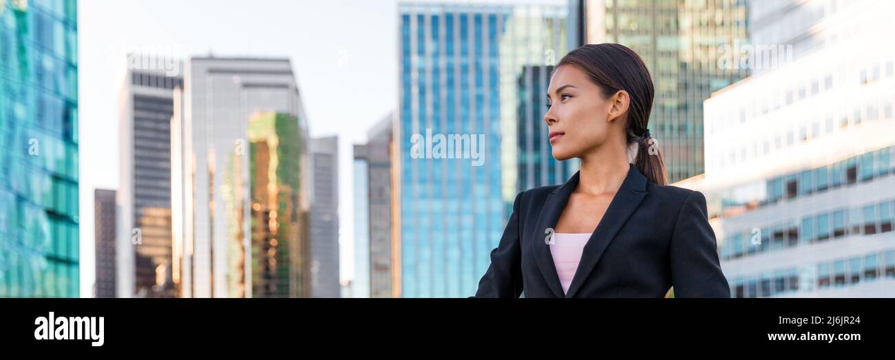 Business woman portrait of young female urban professional businesswoman in suit outside office buildings. Confident successful multicultural Chinese Stock Photo