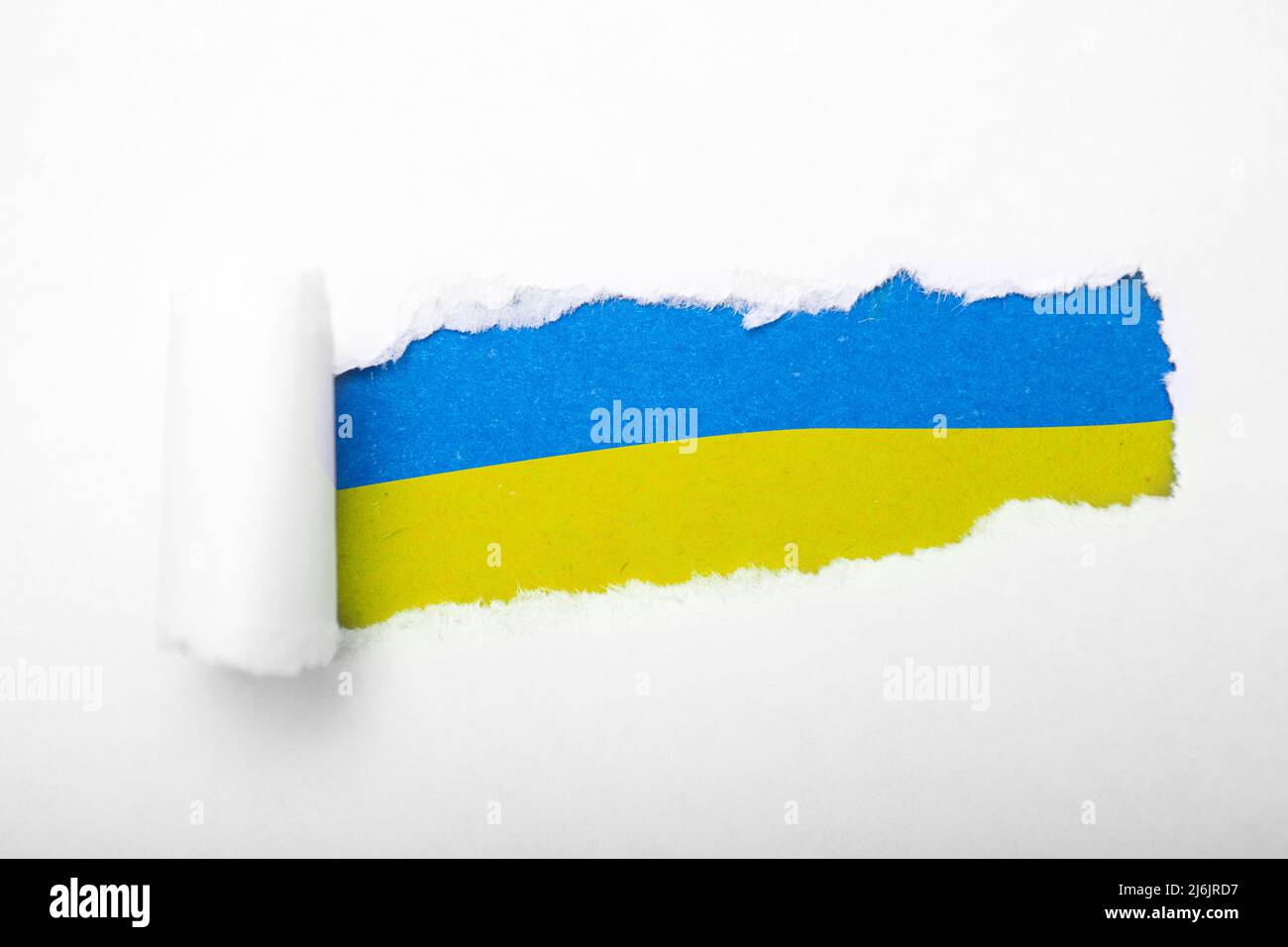 Ukrainian blue and yellow flag in the hole in paper Stock Photo