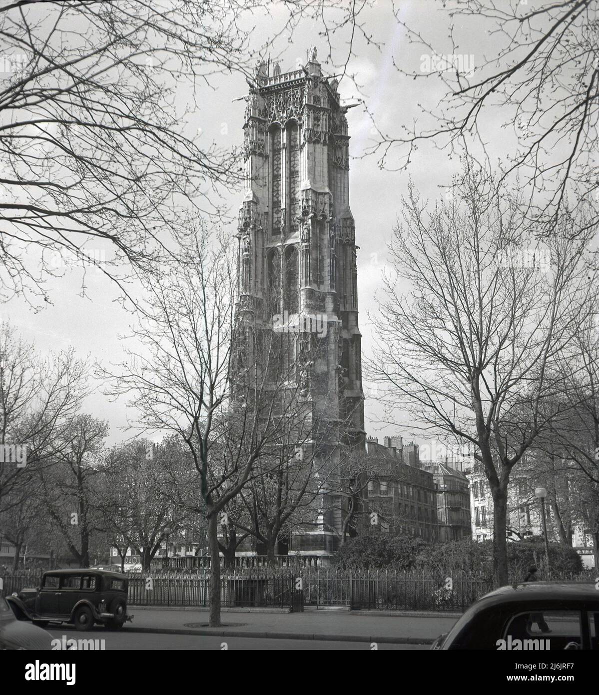 1950s, historical, Tour Saint-Jacques, Paris, France. The gothic tower, formerly a bell tower, is an important French monument and all that remains from a medieval church, Saint-Jacques-de-la-Boucherie, a religious building dedicated to Saint James the Greater who brought Christianity to Spain. Destroyed in the French Revolution, the church had been built in the 12th century, with the tower constructed in the 16th century in the gothic style, an architectural form popular in this era. Somehow surviving the French Revolution, in 1836, the tower was purchased by the city of Paris. Stock Photo