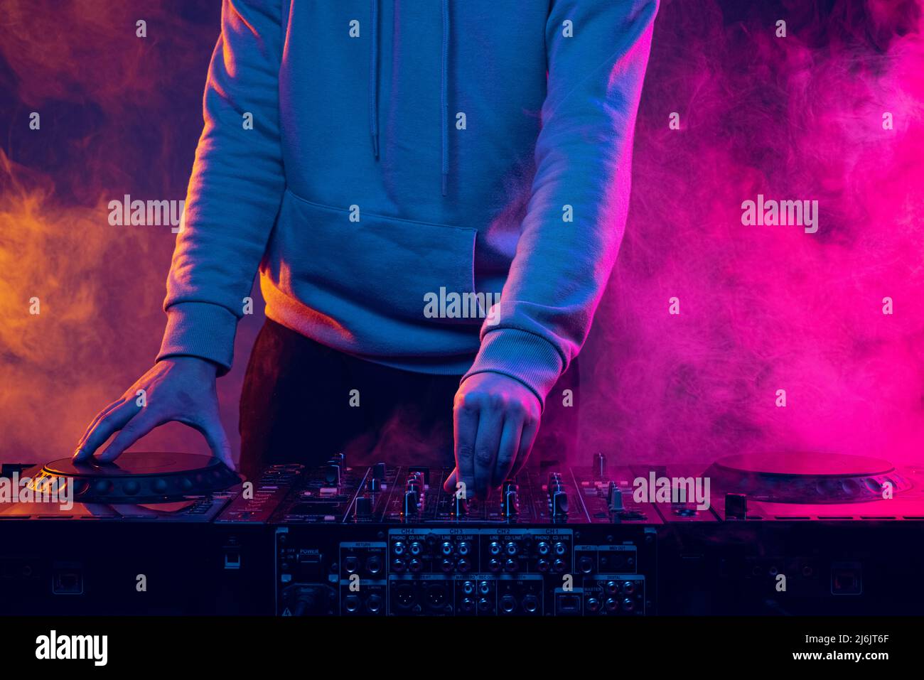 Closeup image in neon lights with smoke effect. Male hands turning