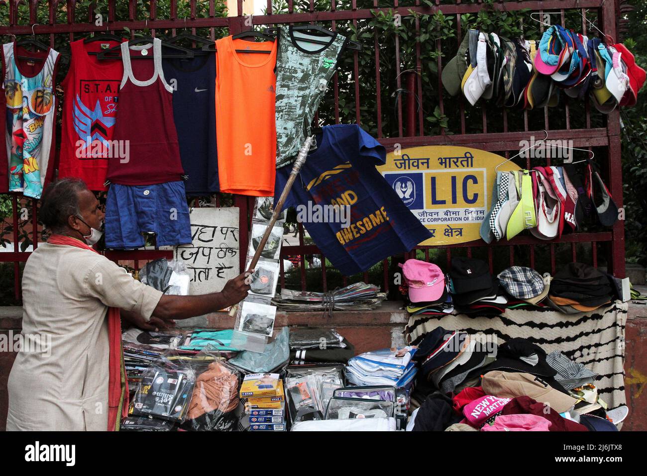 May 2, 2022, New Delhi, New Delhi, India: A shopkeeper removes a t-shirt at a roadside shop outside the Life Insurance Corporation of India (LIC) office. (Credit Image: ©  Karma Sonam Bhutia/ZUMA Press Wire) Stock Photo