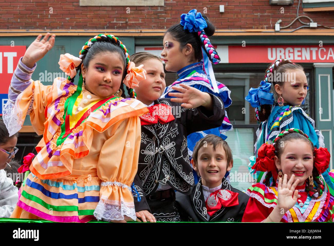 Detroit, Michigan USA - 1 May 2022 - Costumed children ride on a float in the Cinco de Mayo parade in Detroit's Mexican-American neighborhood. Thousands watched the annual parade, which returned in 2022 after a two-year hiatus due to the pandemic. Cinco de Mayo celebrates a Mexican victory over the French on May 5, 1862. Credit: Jim West/Alamy Live News Stock Photo