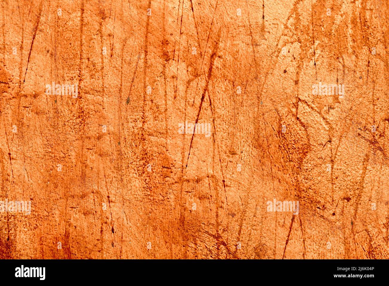 The wall is orange with streaks of paint on it Stock Photo Alamy