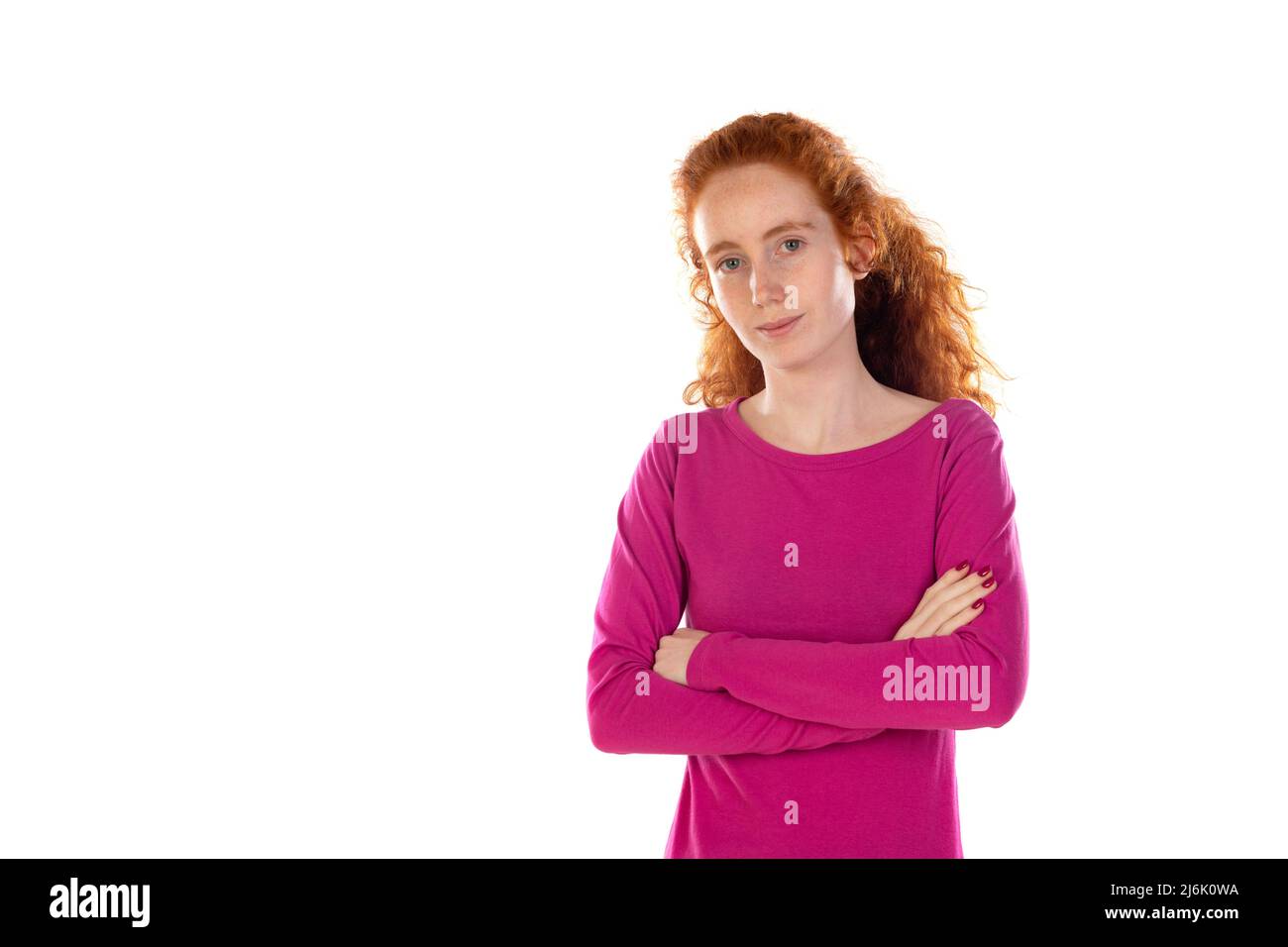 Redhaired young woman wearing a pink t-shirt isolated on a white background Stock Photo