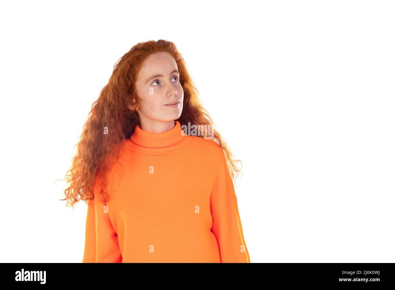 Pensive redhaired girl isolated on a white background Stock Photo