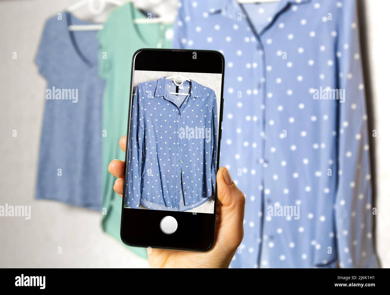 Clothing for sale online on a smartphone screen. Stock Photo