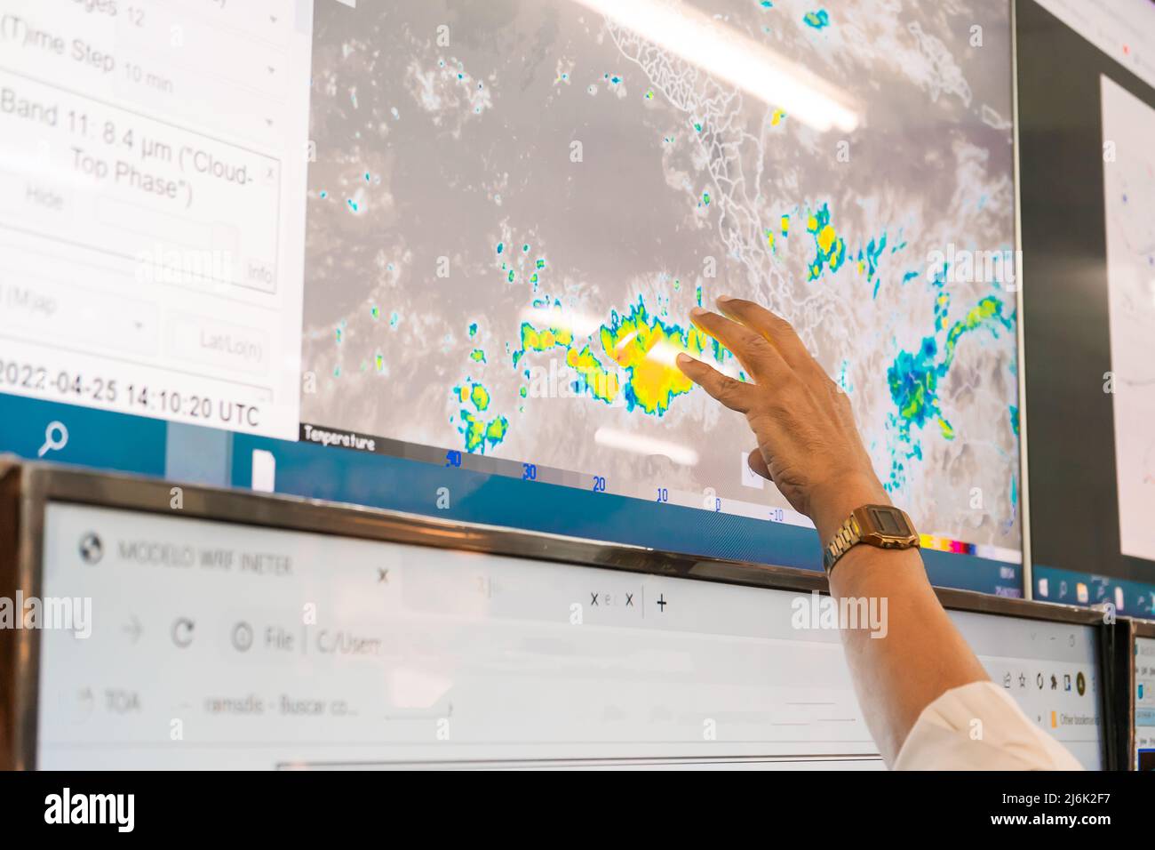 Closeup on the hand of a meteorologist making a weather forecast on a map of graphics Stock Photo