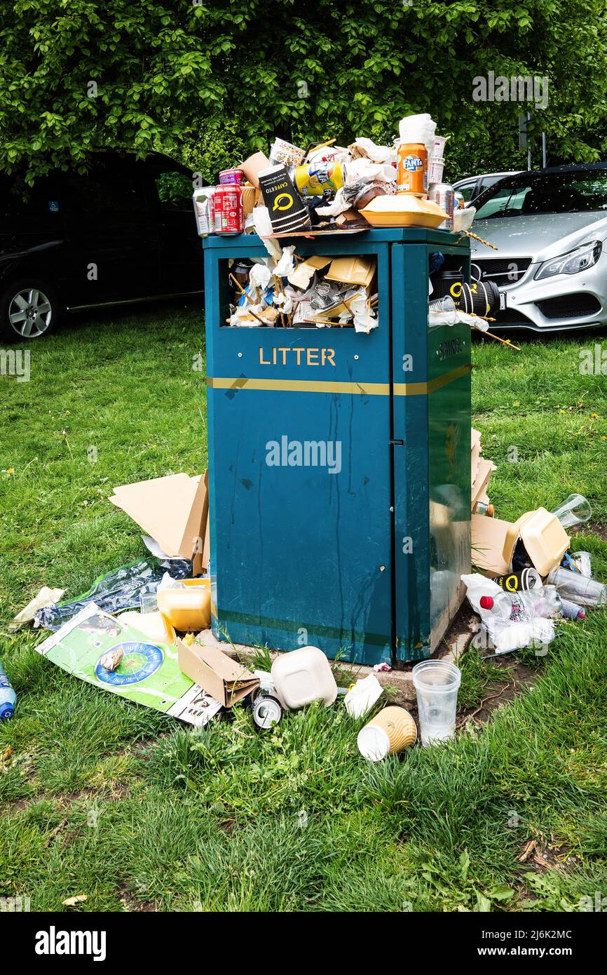 Overflowing rubbish bin, discarded trash, environmental impact Stock Photo