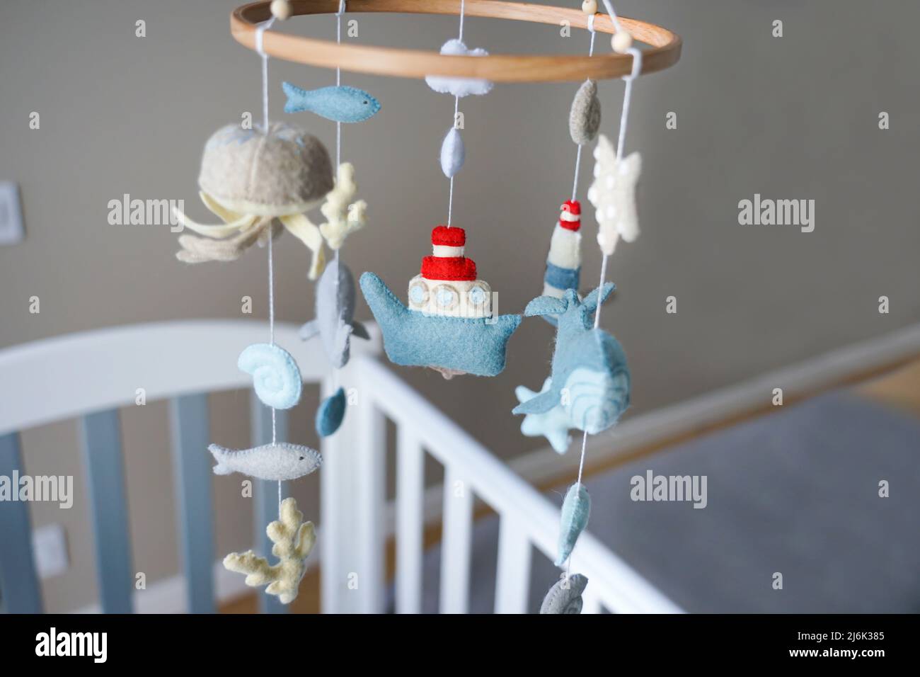 Diy craft baby crib mobile. Toys hang over the crib Stock Photo