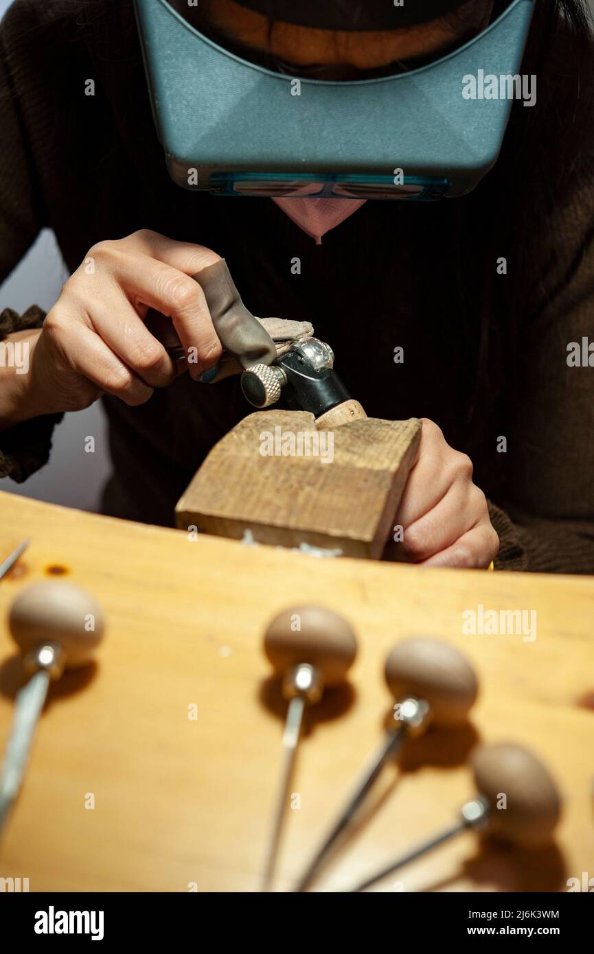 Goldsmith at work in his workshop. Stock Photo