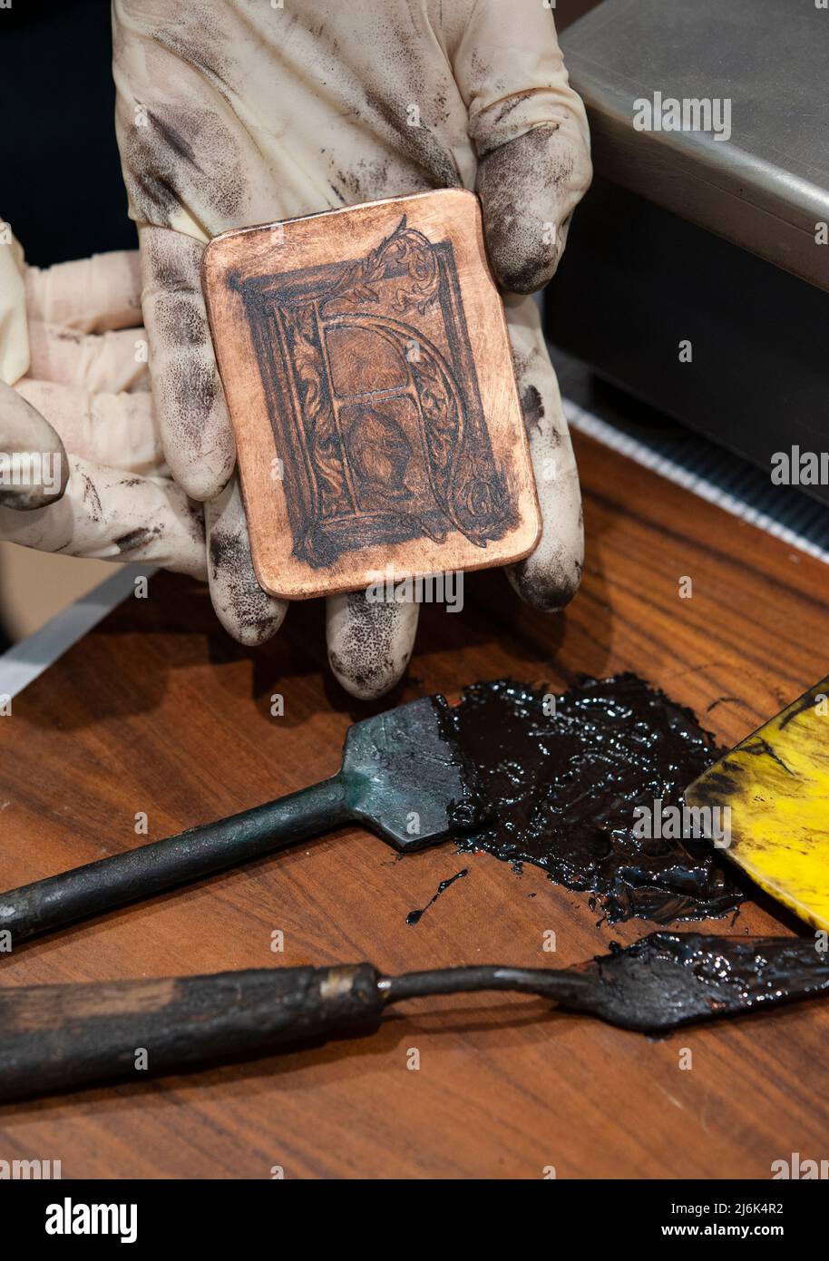 The ancient technique of etching. Engraving of the plate Stock Photo