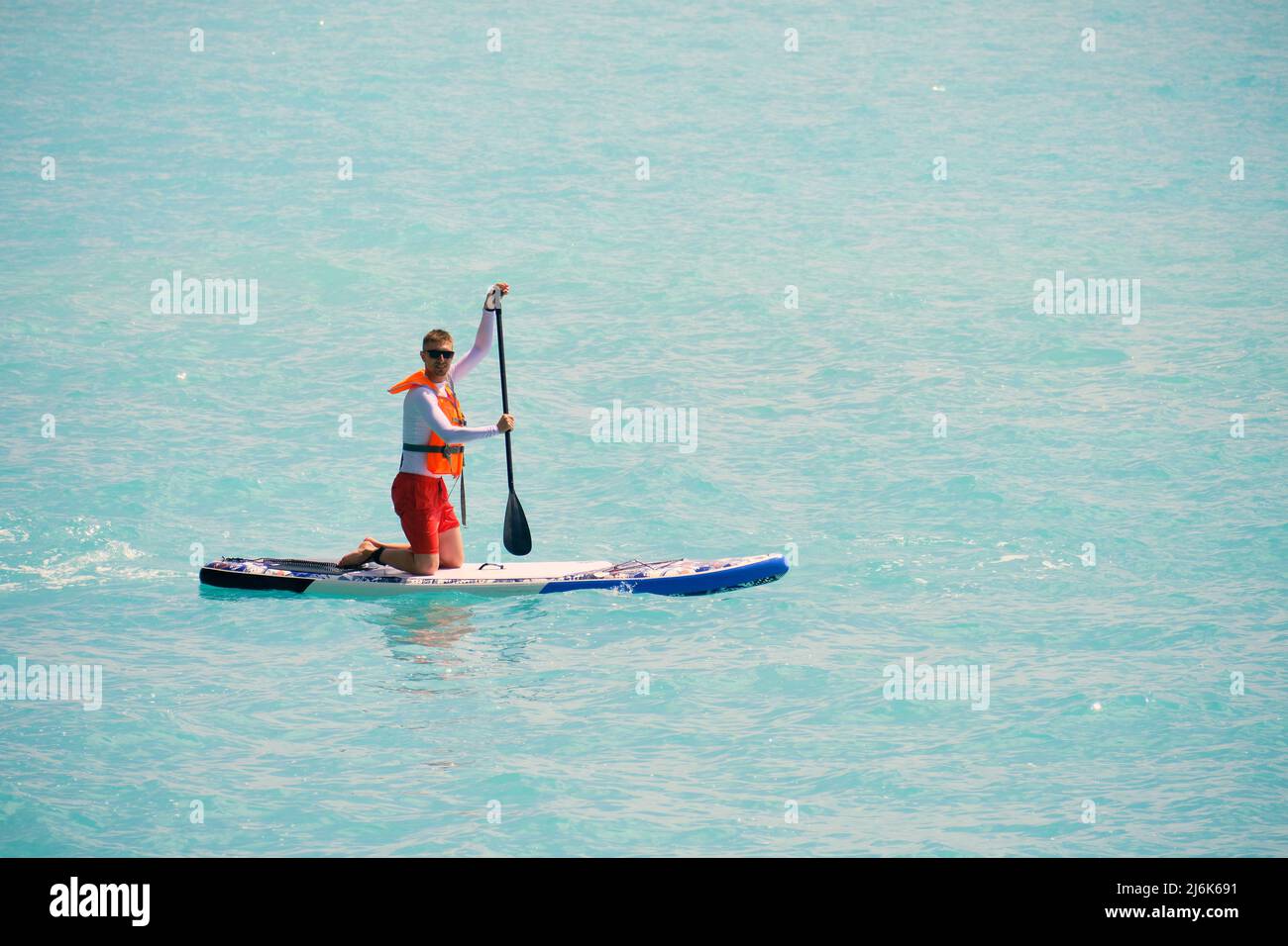 Man paddling on sup board Stock Photo