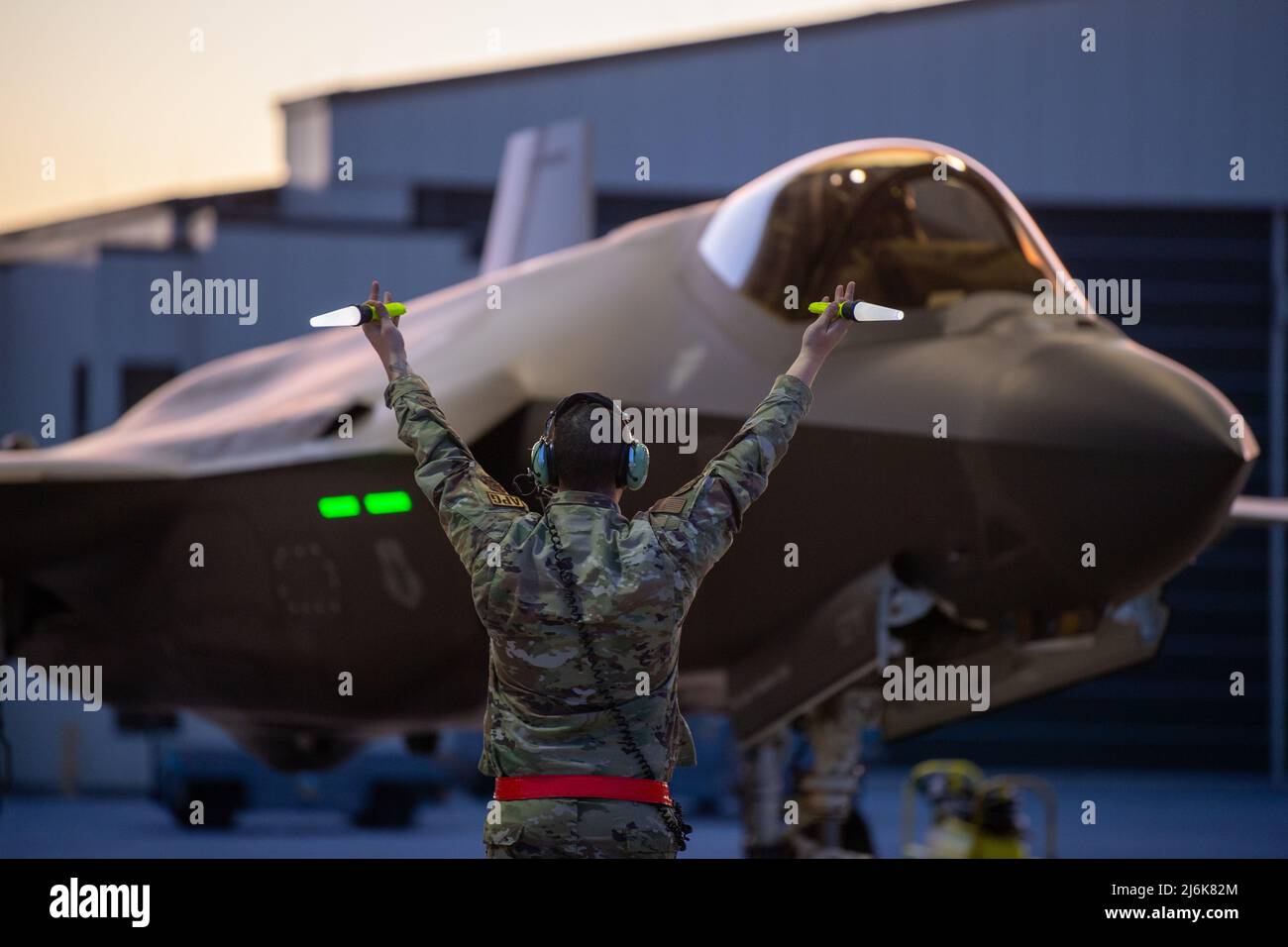 Vermont Air National Guard Base, USA. 2nd May, 2022. Credit: TSgt. Richard Mekkri/US Air Force/Alamy Live NewsBurlington, United States. 02 May, 2022. A U.S. Air Force crew chief assigned to the 158th Fighter Wing, signals a F-35A Lightning II fighter aircraft to taxi as it prepares to depart the Vermont Air National Guard Base, May 2, 2022 in South Burlington, Vermont. The aircraft is rebasing to Spangdahlem Air Base, Germany, to join the NATO Enhanced Air Policing mission. Credit: Planetpix/Alamy Live News Stock Photo