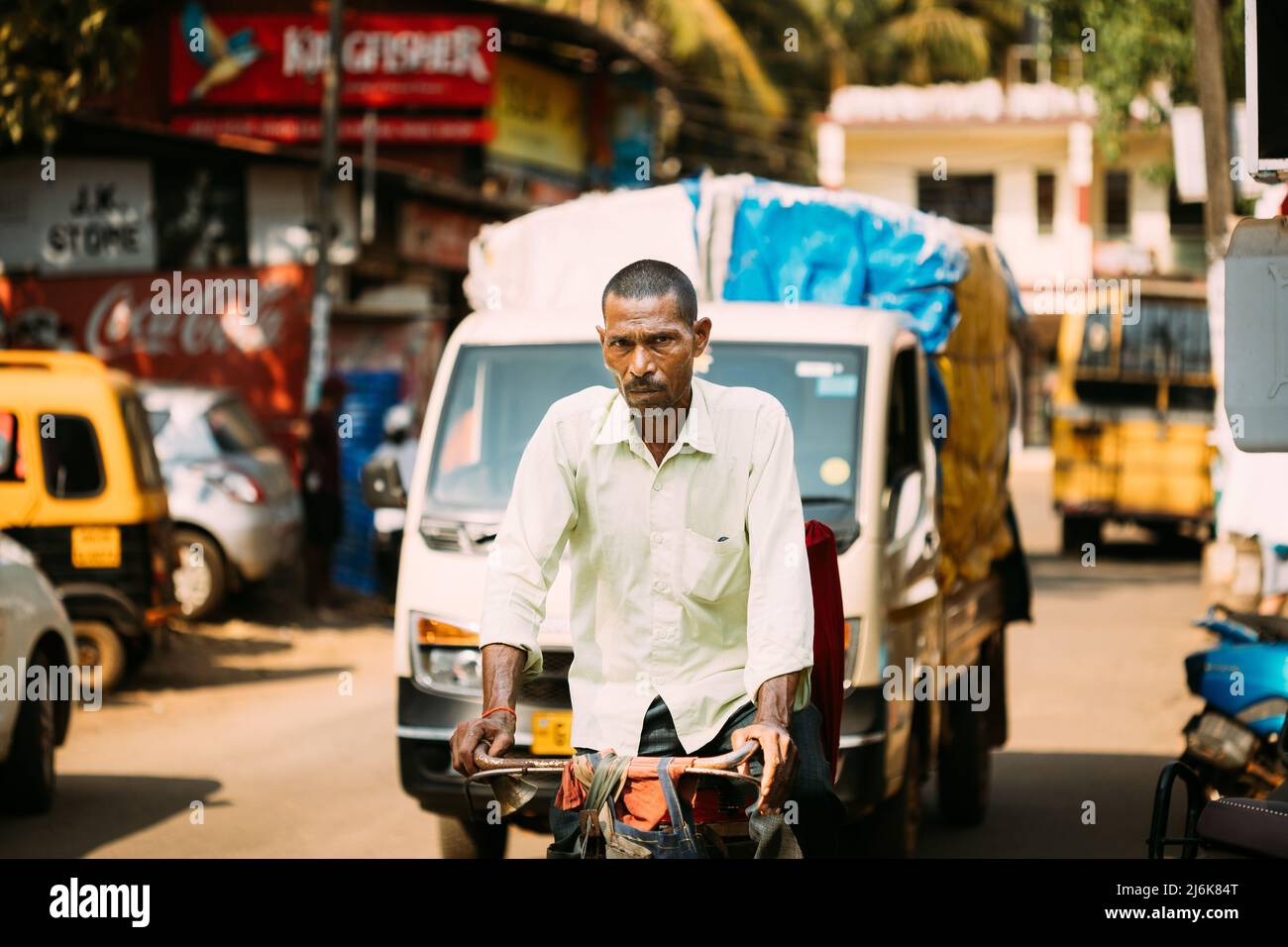 Anjuna, Goa, India. Man Riding On bicycle In The Anjuna street. Stock Photo