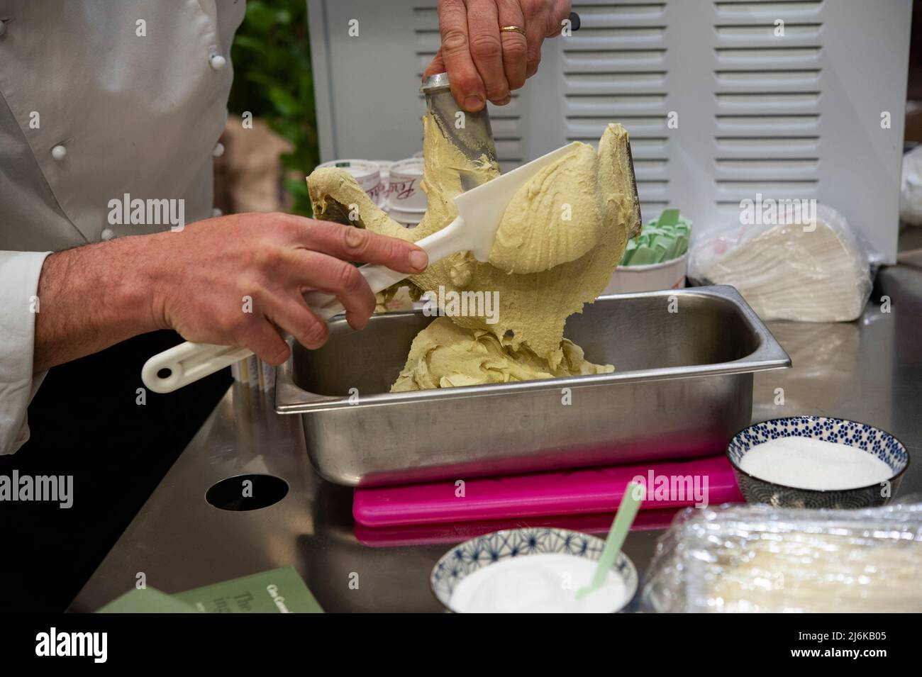 Ice cream man, during pistachio ice cream preparation. Chef at Work. Stock Photo