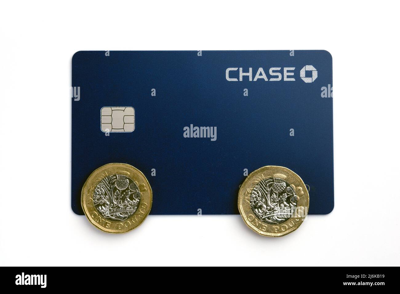 Chase Bank UK debit card with pound coins on top. New digital-only bank launched in the UK by JP Morgan. Stafford, United Kingdom, April 28, 2022 Stock Photo