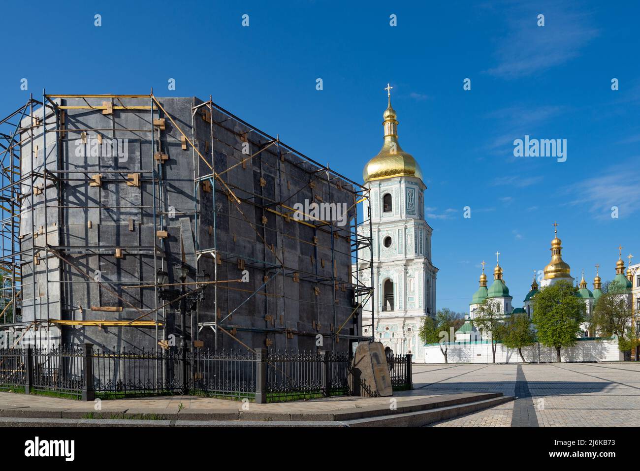 The monument to Bohdan Khmelnytsky is closed with a protective shelter structure against Russian missiles with Sofia Kyivska cathedral on background. Stock Photo