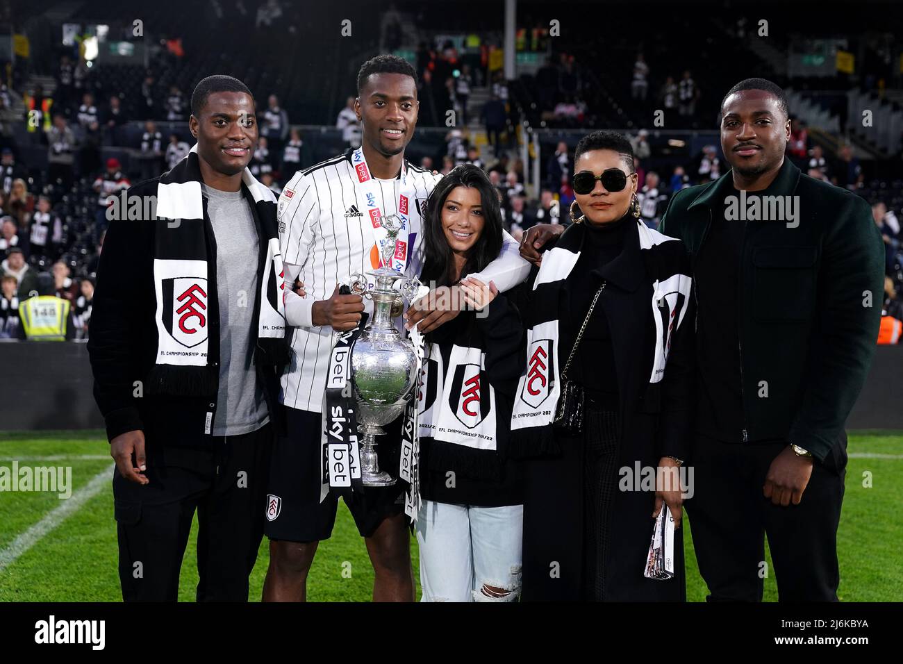 Fulham's Tosin Adarabioyo (second left) celebrates with family and the Championship trophy after being crowned champions after the Sky Bet Championship match at Craven Cottage, London. Picture date: Monday May 2, 2022