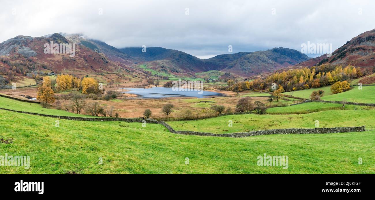 Panoramic view of Little Langdale valley and Little Langdale Tarn in Autumn with Lakeland Fells beyond in the English Lake District, Cumbria, England Stock Photo