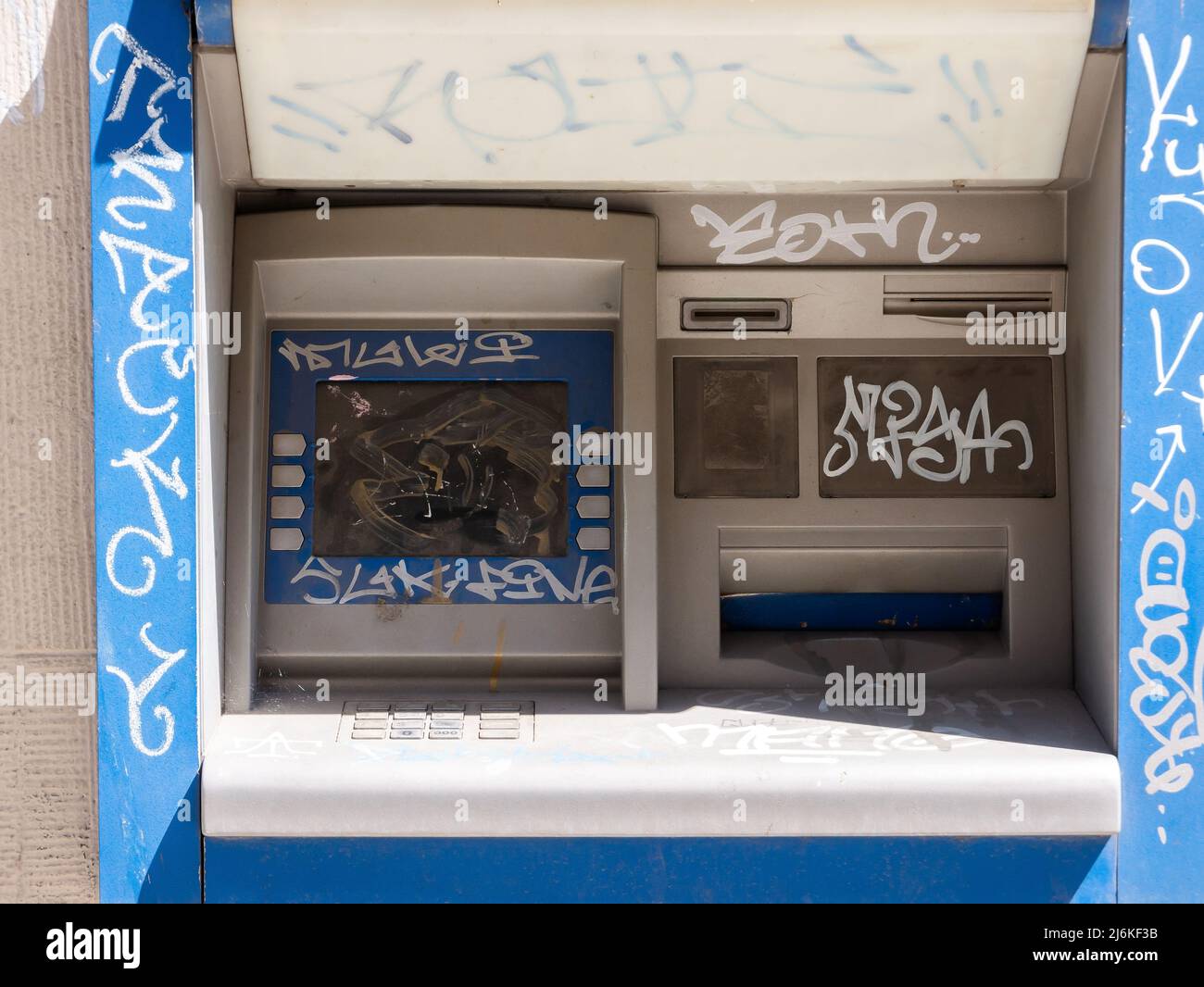 Old damaged destroyed vandalised outdoor ATM, vandalized cash machine detail, closeup. Economical crisis, financial recession, riots, global business Stock Photo
