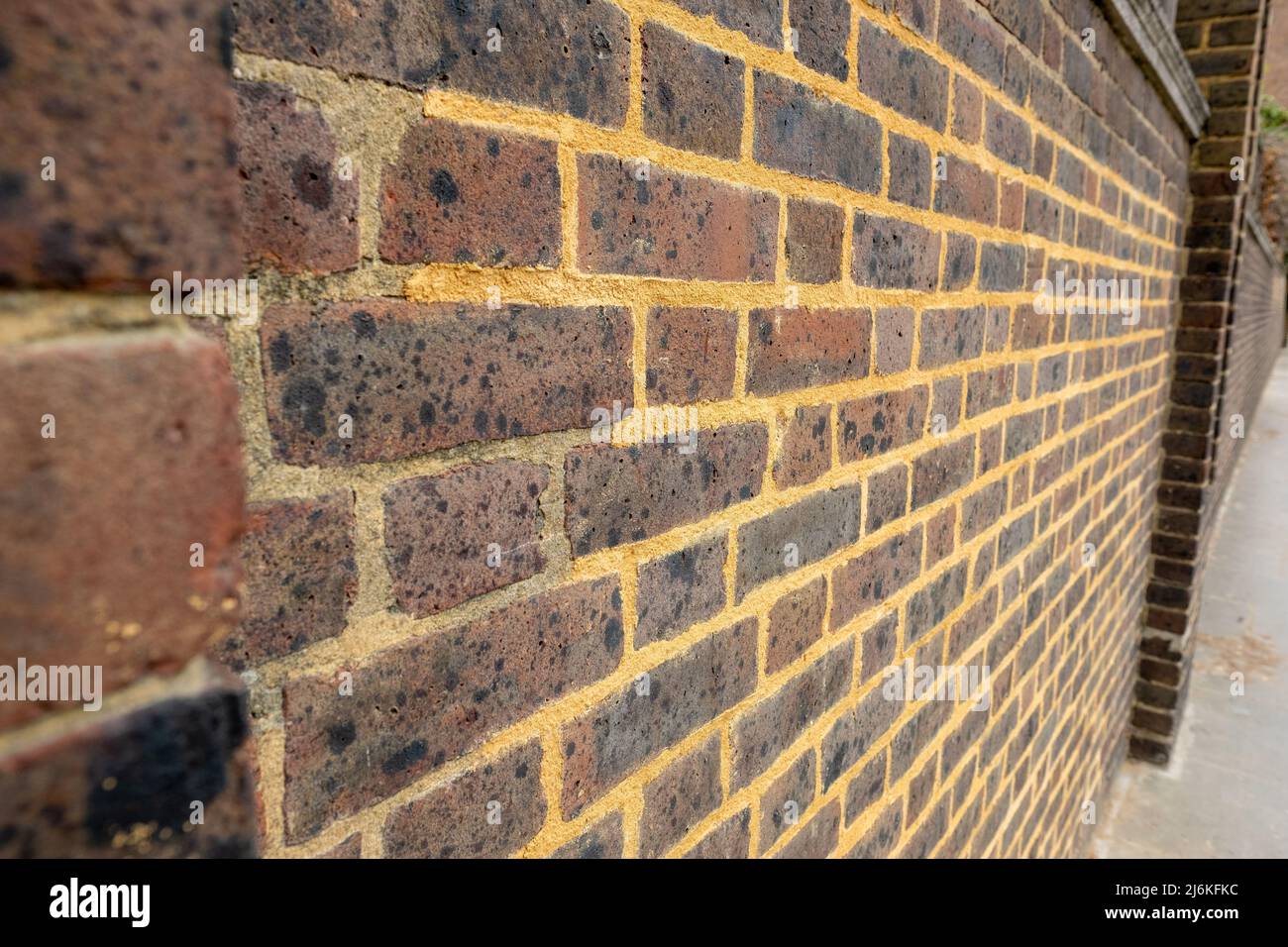 Repointing work on an old brick wall with mortar mix Stock Photo