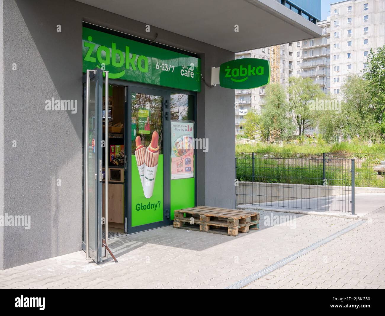Krakow, Poland, Zabka convenience store entrance, facade, front, open doors, nobody, no people. Popular Polish chain store brand, commerce, food retai Stock Photo