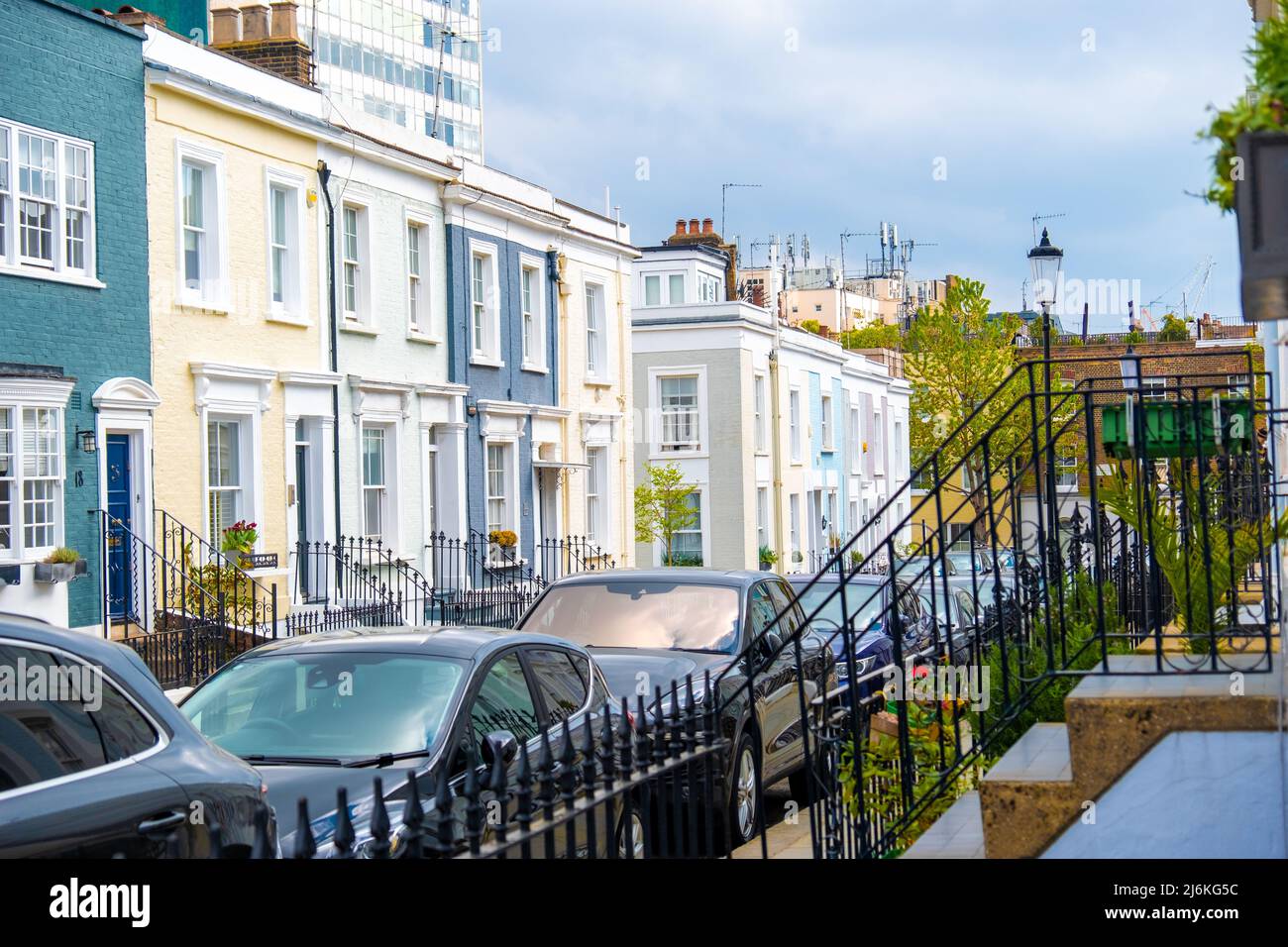 London -April 2022: Colourful street of upmarket townhouses in Notting Hill area of West London Stock Photo