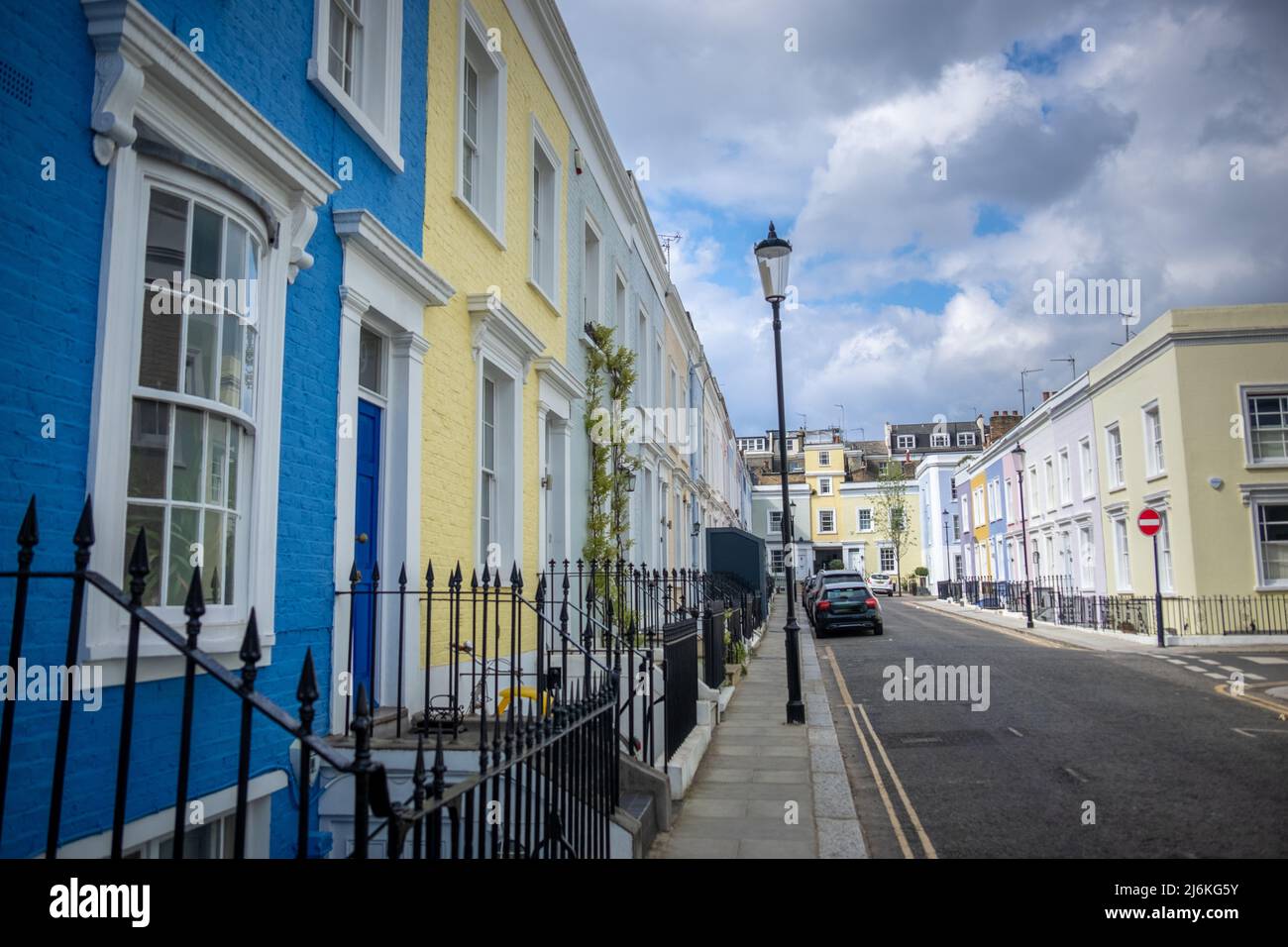 London -April 2022: Colourful street of upmarket townhouses in Notting Hill area of West London Stock Photo