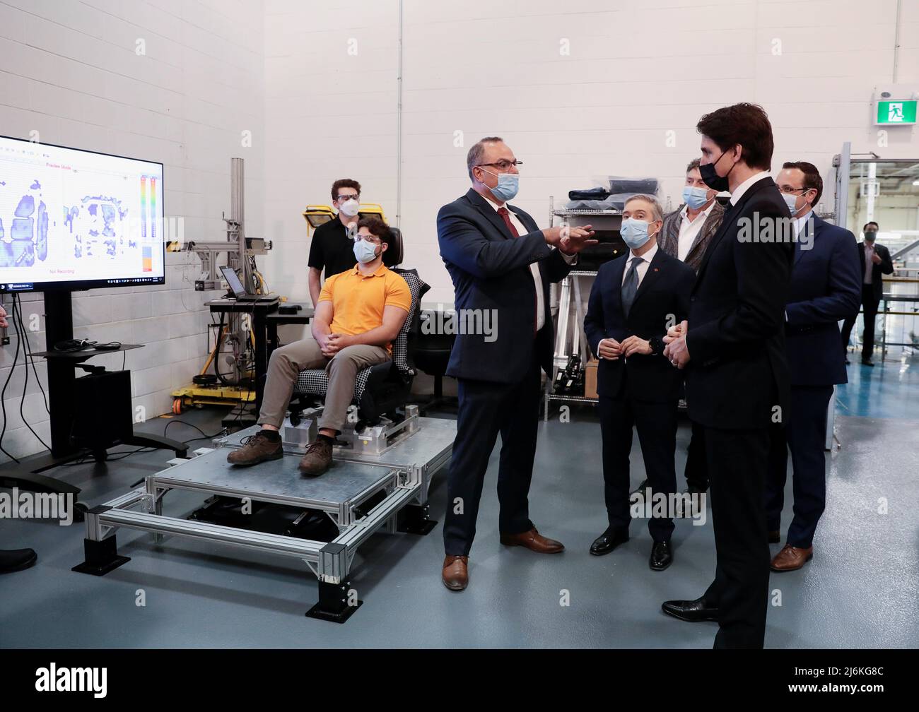 Canadian Prime Minister Justin Trudeau listens to the Director of Canada Engineering at the Stellantis Automotive Research and Development Centre in Windsor, during a tour of the centre, in Windsor, Ontario, Canada May 2, 2022. REUTERS/Rebecca Cook Stock Photo