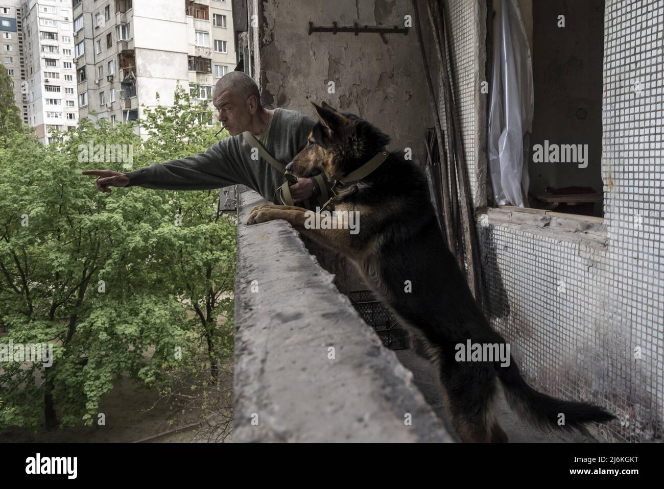 Kharkiv, Ukraine. 02nd May, 2022. Sasha Zolotov, 55, formerly in the military, hangs with his german shepherd, 'Crocodile Dog,' in his old apartment close to the Russian border in Kharkiv, Ukraine, Monday, May 2, 2022. Zolotov's apartment was hit twice just a few weeks apart. The apartment burned down and all he had left were the clothes he was wearing and his passport. Zolotov now lives in the basement turned bomb shelter.    Photo by Ken Cedeno/UPI Credit: UPI/Alamy Live News Stock Photo