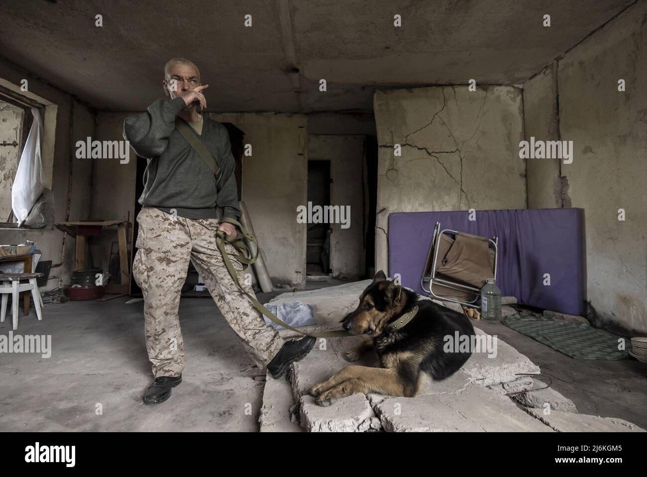 Kharkiv, Ukraine. 02nd May, 2022. Sasha Zolotov, 55, formerly in the military, hangs with his german shepherd, 'Crocodile Dog,' in his old apartment close to the Russian border in Kharkiv, Ukraine, Monday, May 2, 2022. Zolotov's apartment was hit twice just a few weeks apart. The apartment burned down and all he had left were the clothes he was wearing and his passport. Zolotov now lives in the basement turned bomb shelter.    Photo by Ken Cedeno/UPI Credit: UPI/Alamy Live News Stock Photo