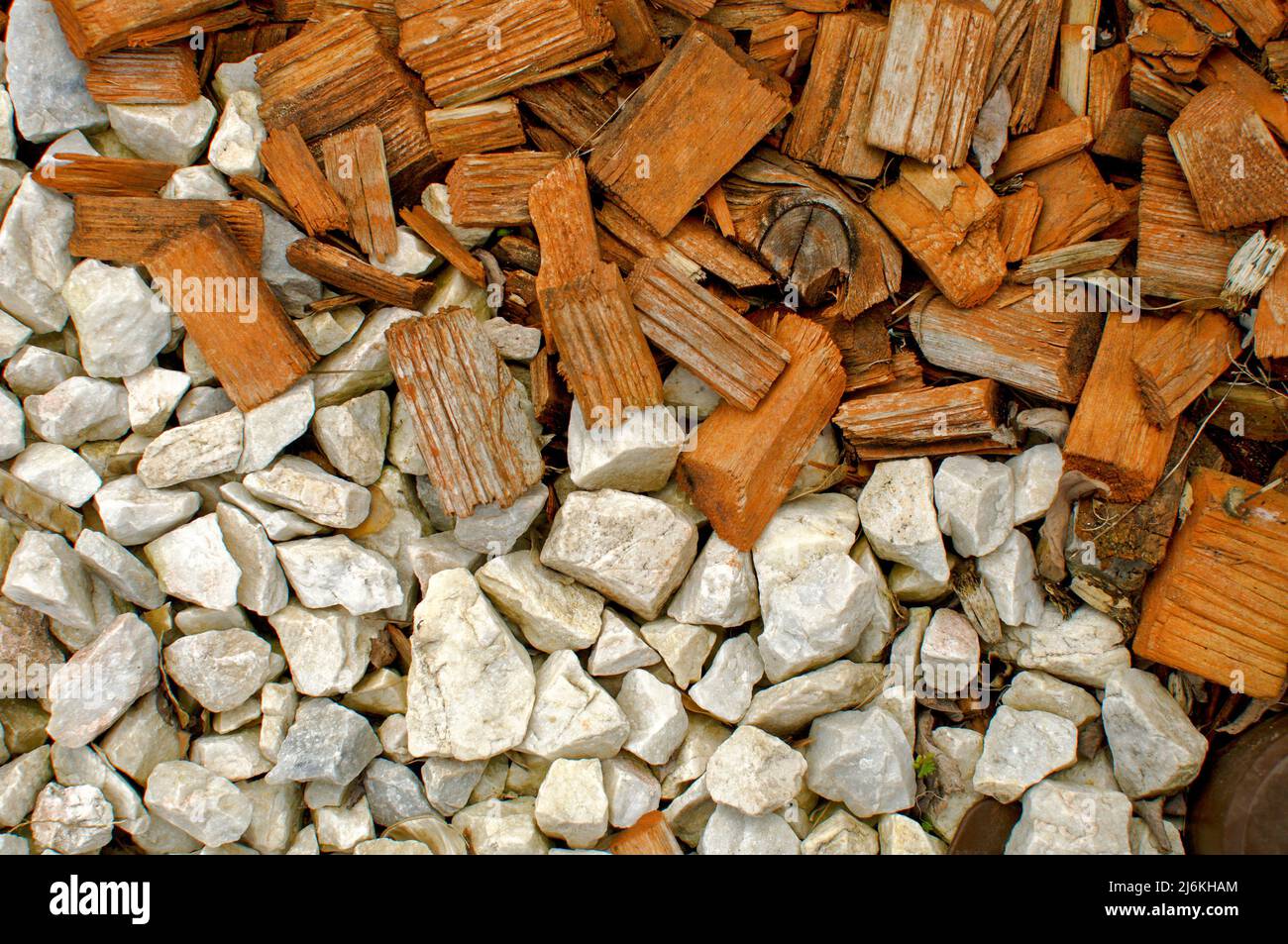 Texture of white stones and small pieces of colored wood, flat layout, wallpaper for various projects Stock Photo