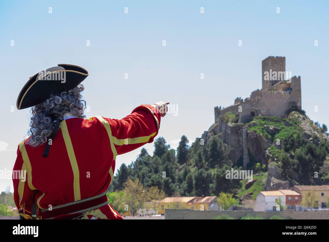 An unrecognizable person pointing to the castle of Almansa, Spain Stock Photo