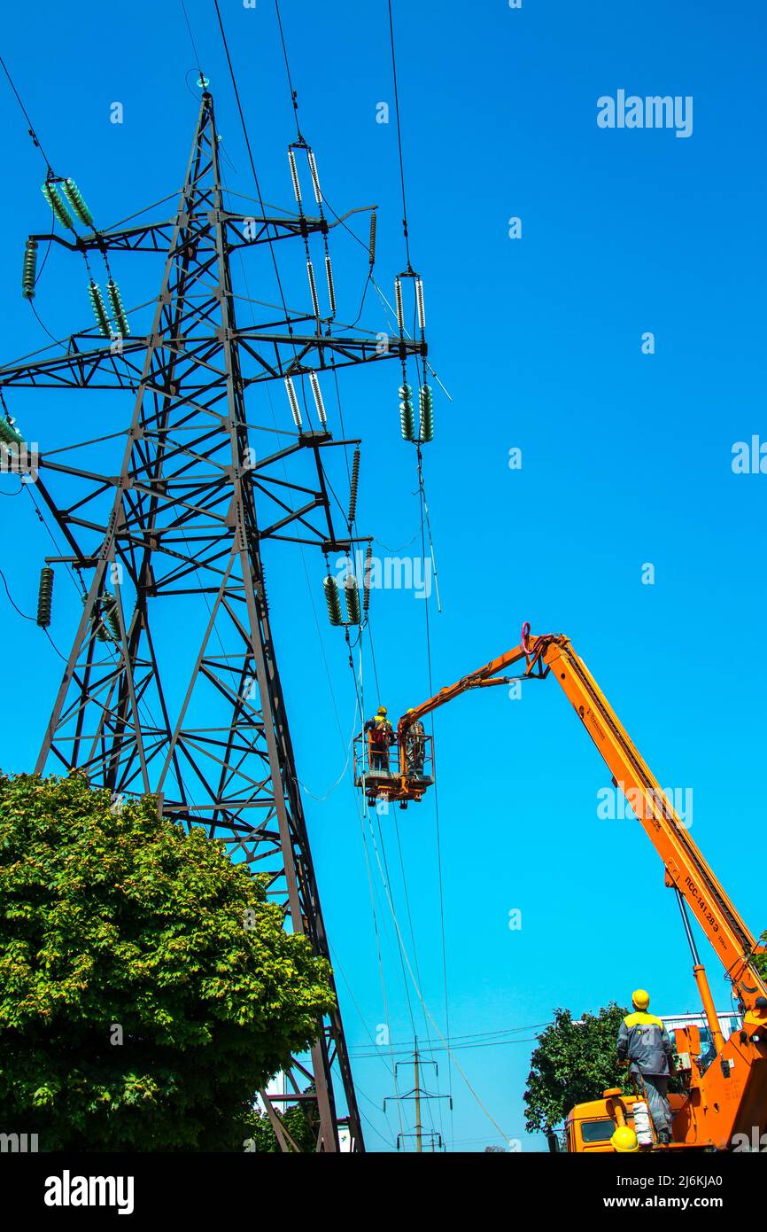 Dnipropetrovsk, Ukraine 08.08.2021 Repair of power transmission lines. Workers with the help