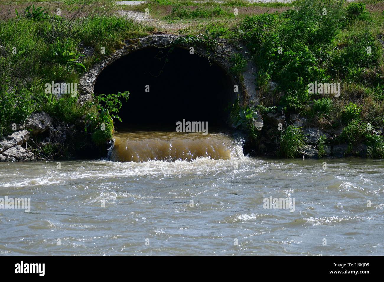 Dirty sewage from the pipe, environmental pollution Stock Photo
