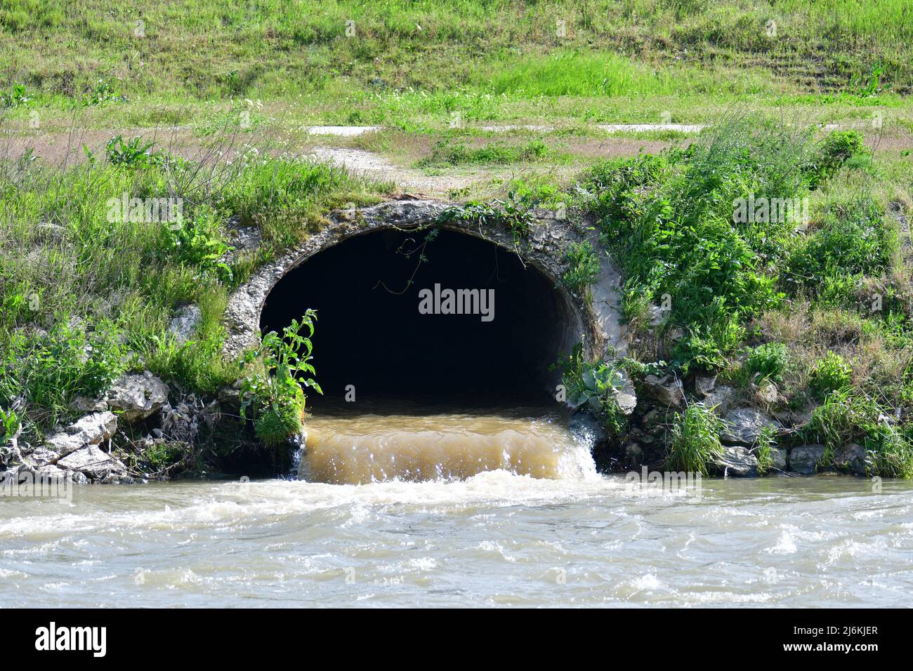 Dirty sewage from the pipe, environmental pollution Stock Photo