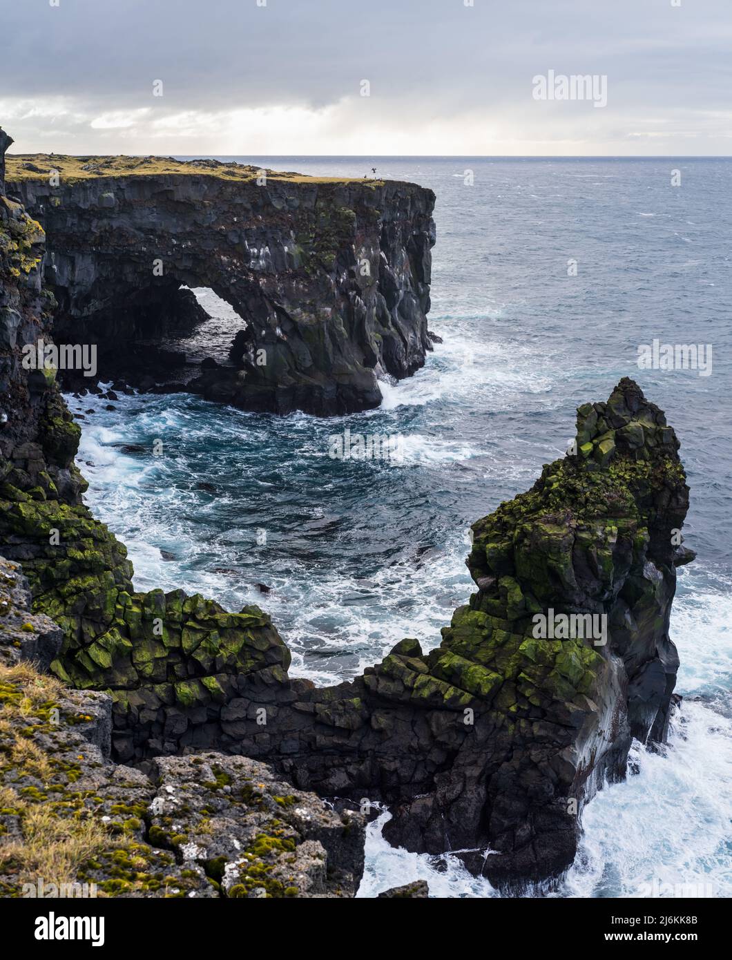 View during auto trip in East Iceland, Snaefellsnes peninsula, View Point near Svortuloft Lighthouse. Spectacular black volcanic rocky ocean coast wit Stock Photo