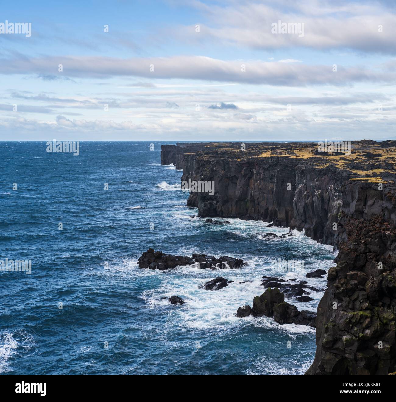 View during auto trip in East Iceland, Snaefellsnes peninsula, View Point near Svortuloft Lighthouse. Spectacular black volcanic rocky ocean coast wit Stock Photo