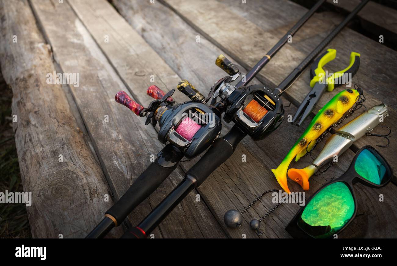Old fishing tackle rods and reels in a corner with hiking boots Stock Photo  - Alamy