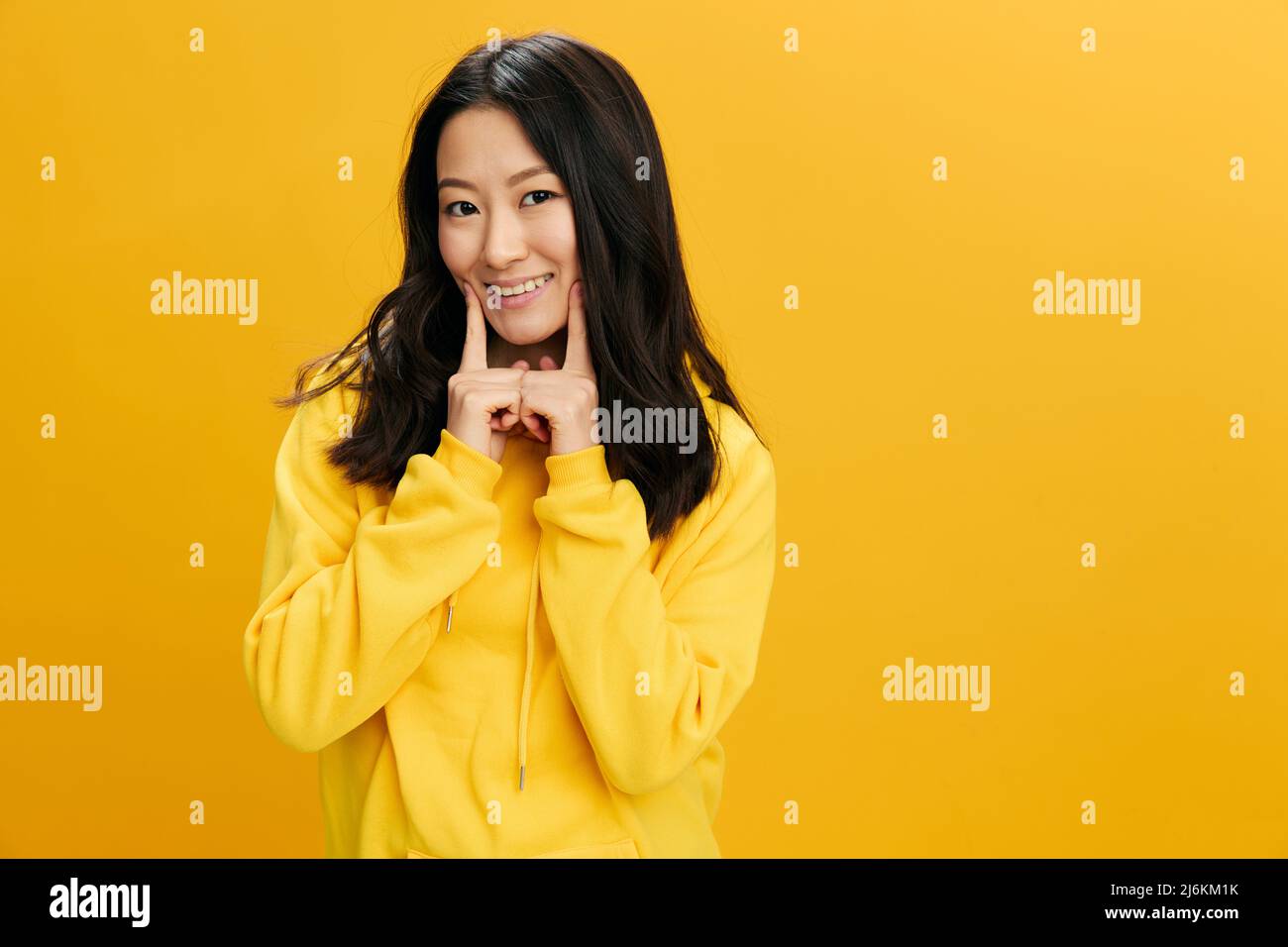 Asian girl in mustard hoodie long hair