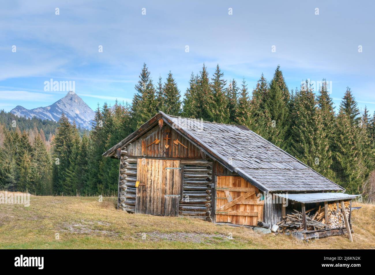 Lonely old wooden barns in the Eastern Alps of Tyrol give the landscape a special flair. Stock Photo