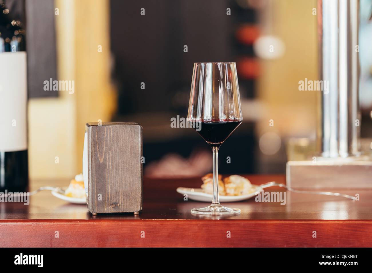 glass of red wine at the bar of a restaurant Stock Photo