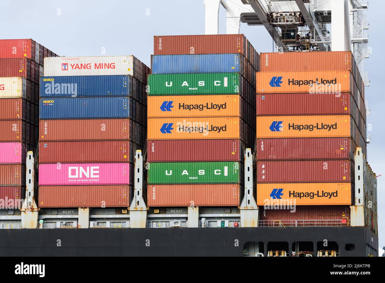 Seattle - April 03, 2022; Intermodal shipping containers stacked on a ship as a part of the global trade economy. Stock Photo