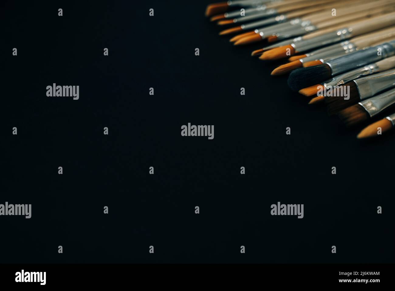 paint brushes on black background Stock Photo - Alamy