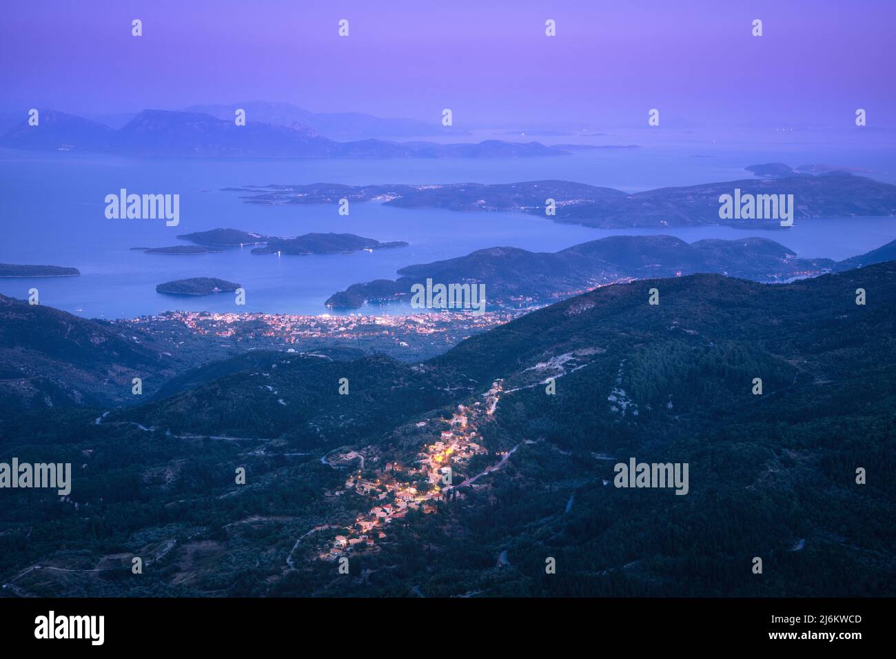Small village in the mountain and city on the sea cost at night Stock Photo