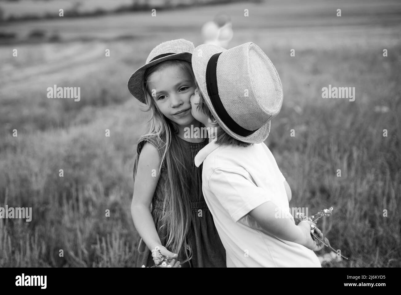 Child playing Happy childhood. Love concept. Romantic and love. Sweet angel children. Kid having fun in spring field. Valentines day card. Stock Photo