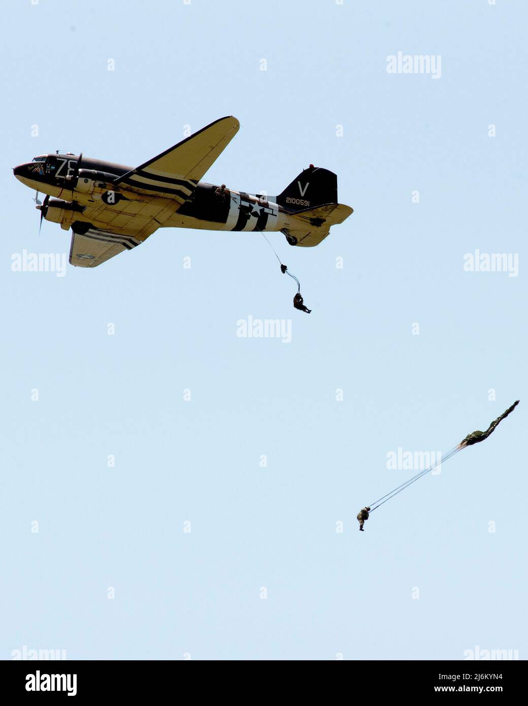 World War II paratroop reenactors jump from Tico Belle, a C-47 Skytrain, on April 27, 2022, over the National Museum of the U.S. Air Force at Wright-Patterson Air Force Base, Ohio. The aircraft, a veteran of the D-Day invasion, then landed on the runway behind the museum and was on display until its departure the next day. (U.S. Air Force photo by R.J. Oriez) Stock Photo